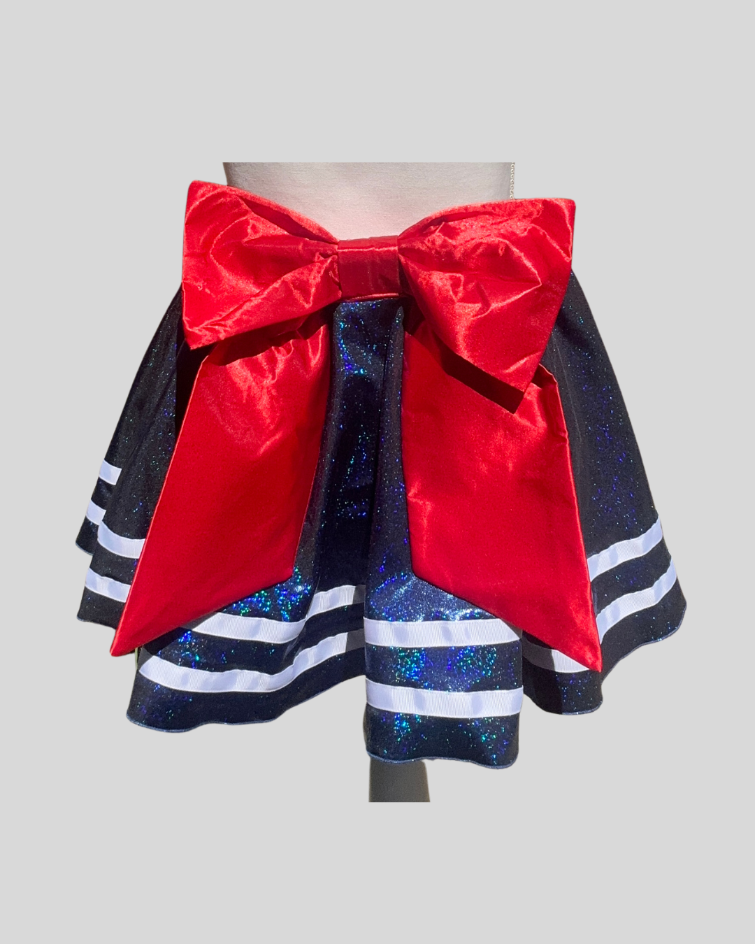 Running Skirt with red bow and blue glittery layers on a white background