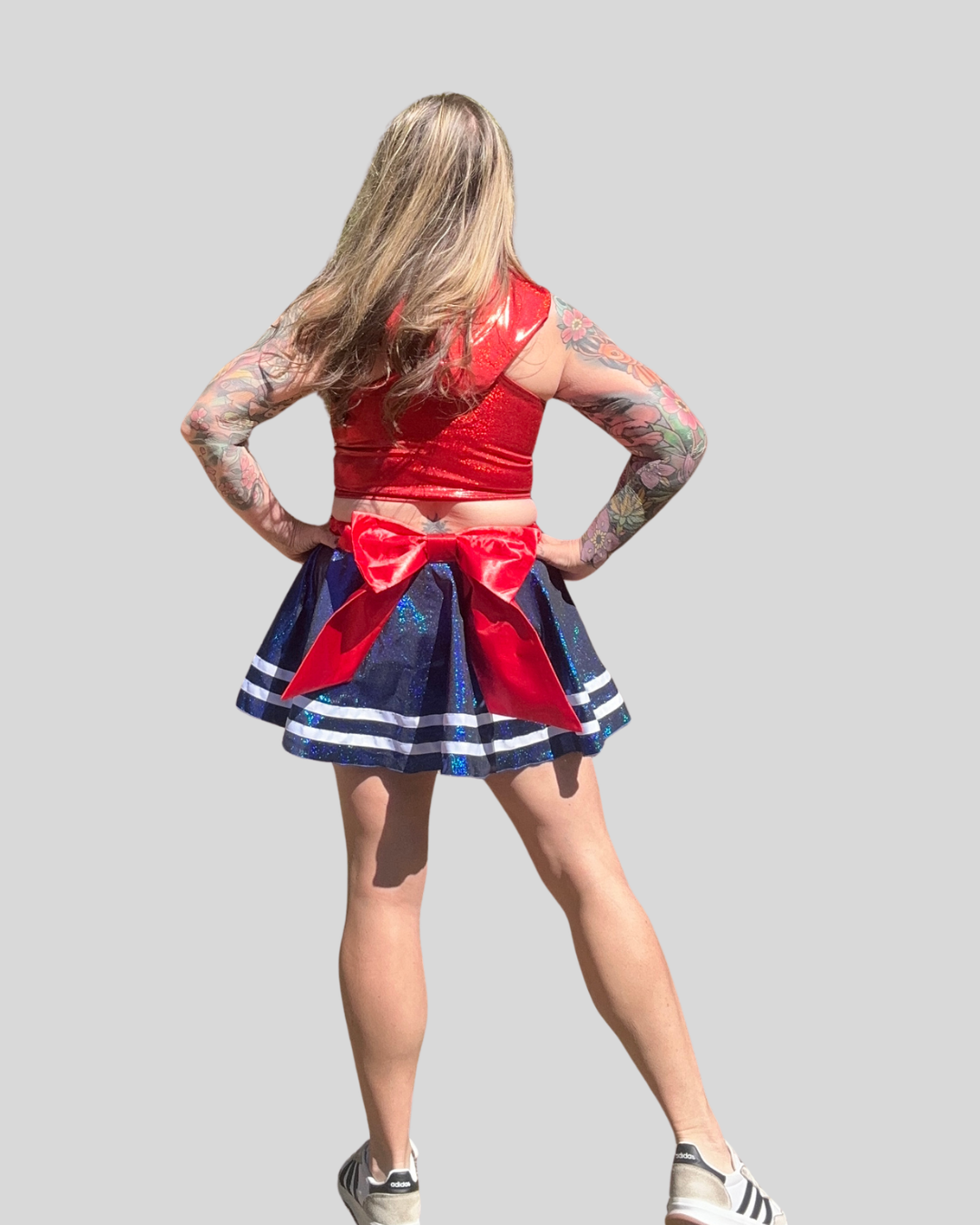 model wearing sparkly royal blue running skirt with red waistband and bow, versatile patriotic running outfit