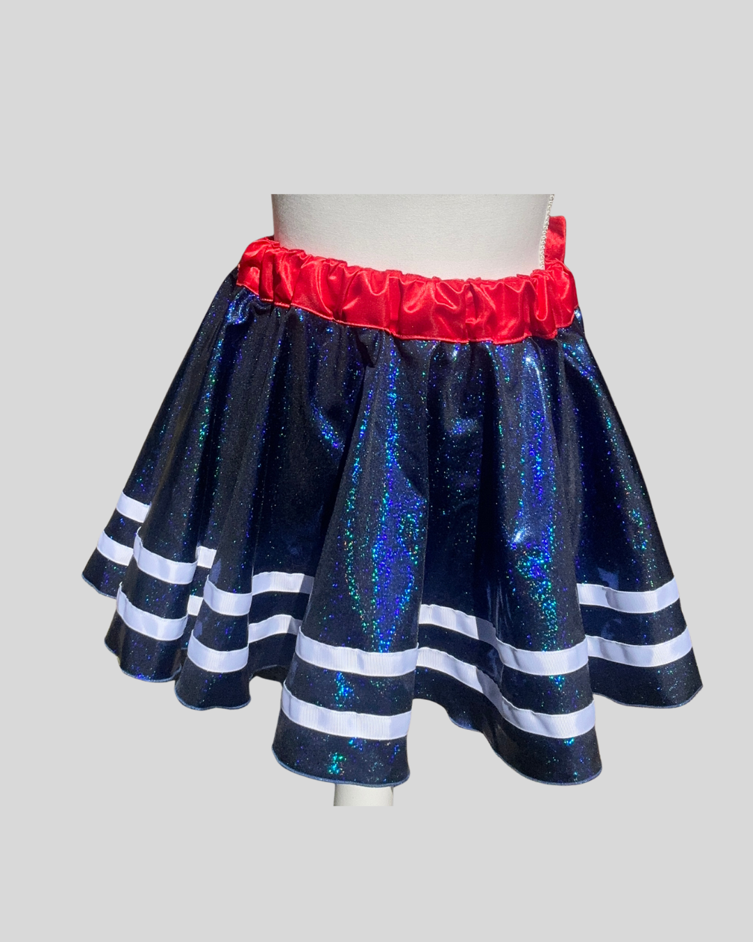 front view sparkly royal blue running skirt with red waistband and bow, versatile patriotic running outfit