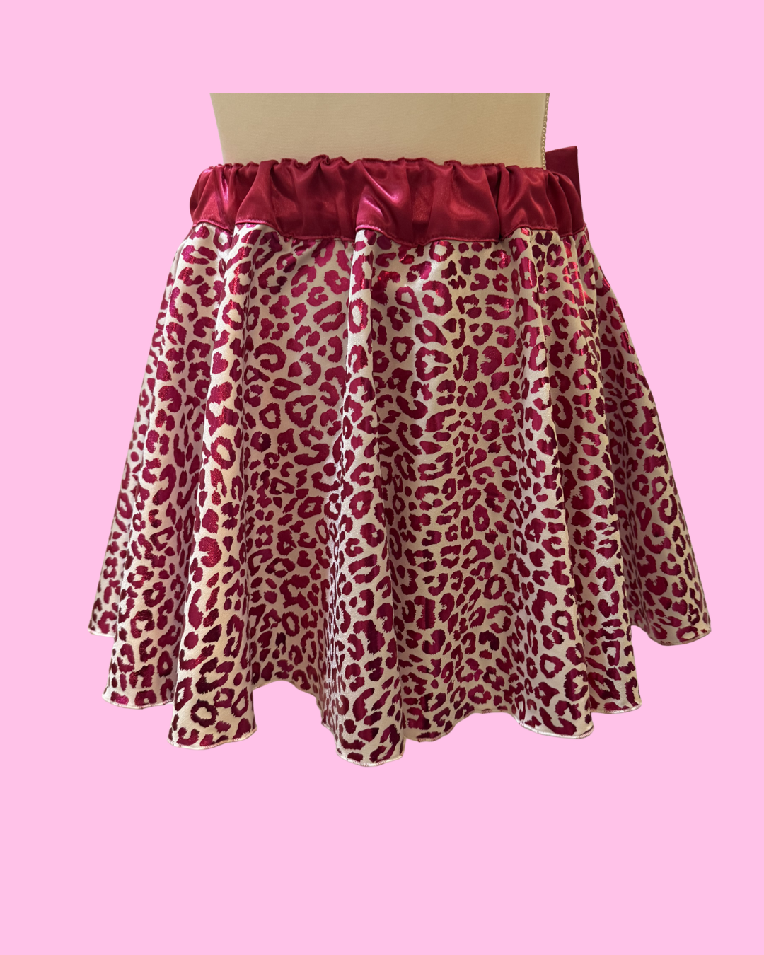 front view sparkly white running skirt with pink cheetah print overlay and hot pink waistband and bow for bold race outfit