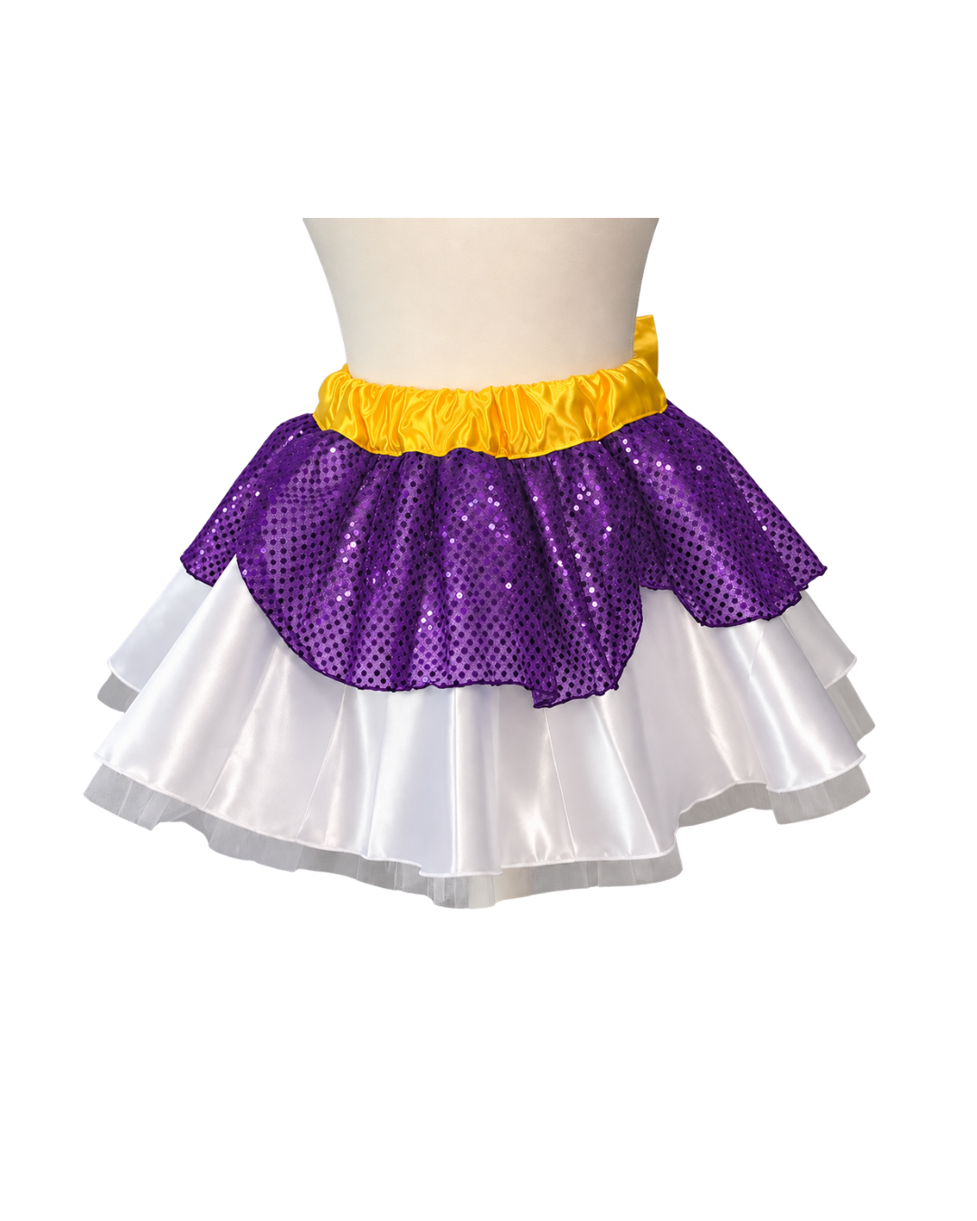 A two-tiered tutu skirt displayed on a mannequin torso. The top tier is made of purple sequins with a yellow ruffled waistband, and the bottom tier is made of white satin ruffles.