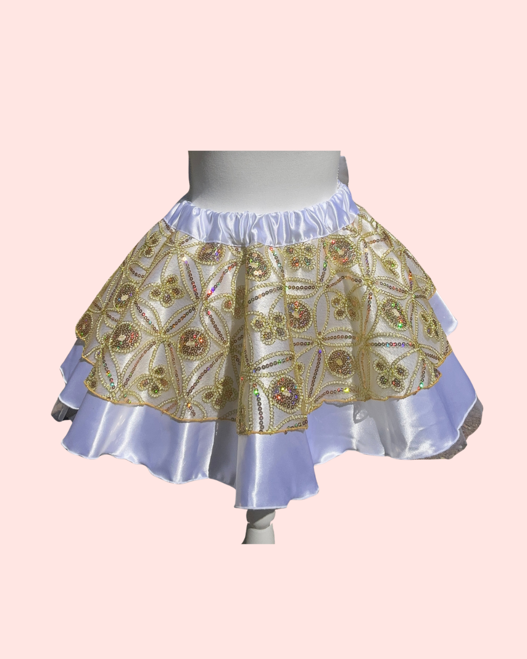 running Skirt with gold and white pattern on a pink background