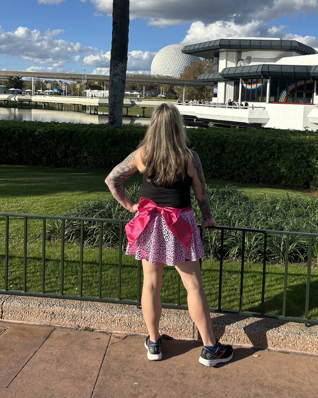 Person wearing a pink running skirt with cheetah print 